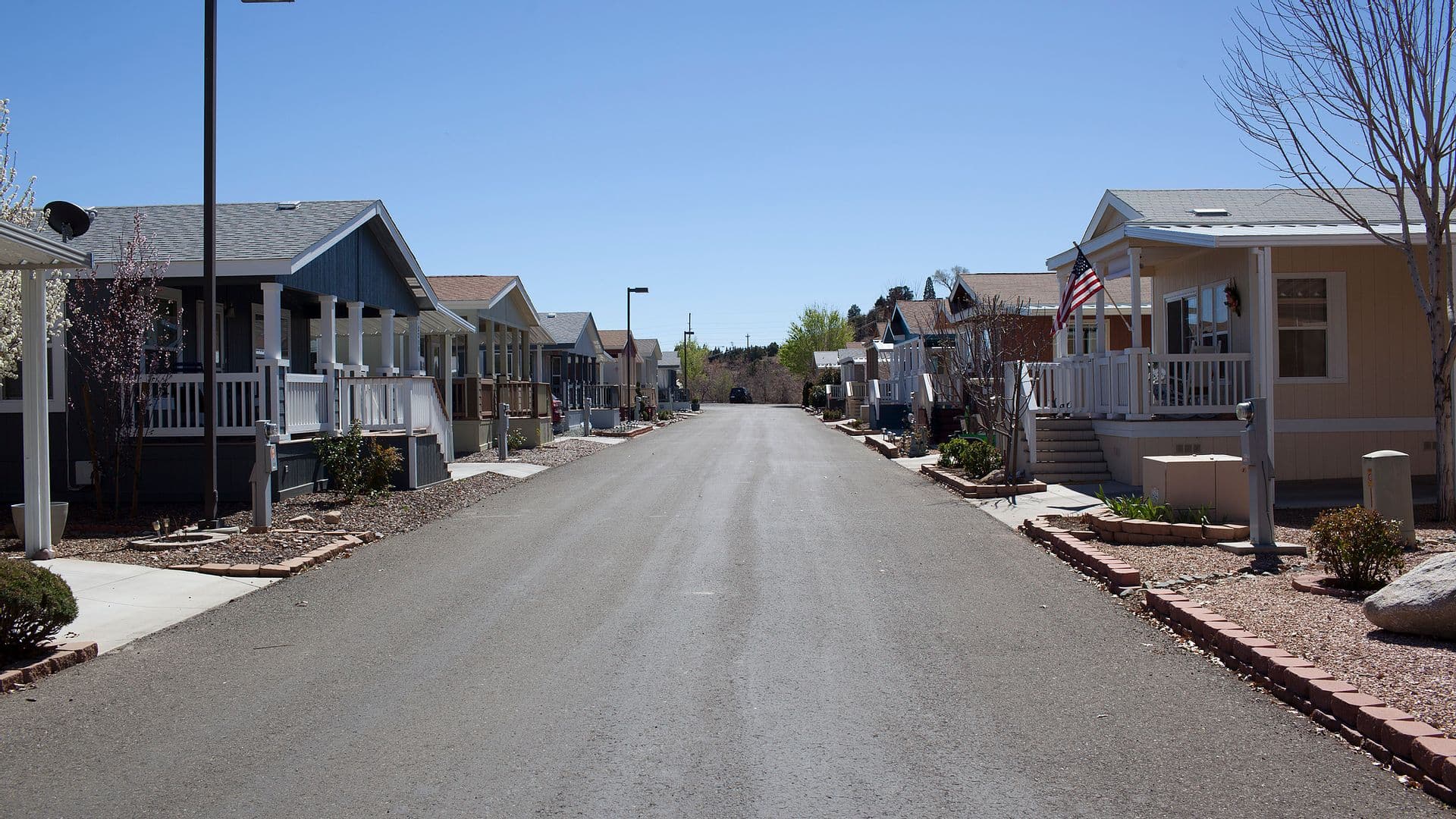 A tree-lined street of homes at Orchard Ranch RV Resort in Dewey, Arizona.