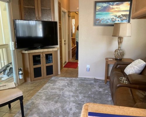 241-Livingroom-Hallway-with-Door-to-Screened-in-Patio-Shed